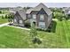 Beautiful two-story home with brick and stone exterior and manicured lawn at 15694 Provincial Ln, Fishers, IN 46040