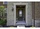 Close up of front door entry with stone surround and a dark wood door at 15694 Provincial Ln, Fishers, IN 46040