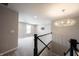 Hallway with railing looking into a loft with a window at 15694 Provincial Ln, Fishers, IN 46040