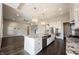 Open kitchen with island, granite countertops, modern lighting, and stainless-steel sink and appliances at 15694 Provincial Ln, Fishers, IN 46040