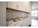 Kitchen featuring white cabinets, granite countertops, and tile backsplash at 15694 Provincial Ln, Fishers, IN 46040
