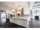 Modern kitchen featuring granite countertops, pendant lighting, stainless steel appliances, and white cabinetry at 15694 Provincial Ln, Fishers, IN 46040