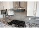 Modern kitchen with granite countertops, stainless steel appliances, gray backsplash, and overhead vent at 15694 Provincial Ln, Fishers, IN 46040