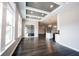 Open-concept room with a coffered ceiling, lots of natural light, and hardwood floors at 15694 Provincial Ln, Fishers, IN 46040