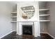 Living room fireplace and shelving with round mirror at 15694 Provincial Ln, Fishers, IN 46040