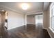 Open-concept living space with dark wood floors, white walls, and an abundance of natural light at 15694 Provincial Ln, Fishers, IN 46040