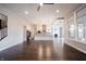 Open concept living space showcasing hardwood floors, kitchen with island, and staircase leading to the upper level at 15694 Provincial Ln, Fishers, IN 46040