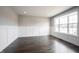 Bright living room featuring stylish wainscoting, hardwood floors, and a large window providing natural light at 15694 Provincial Ln, Fishers, IN 46040