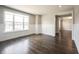 Living room with wood floors, white wainscoting, and a large window at 15694 Provincial Ln, Fishers, IN 46040