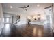 Spacious living room and kitchen with hardwood floors, stainless steel appliances, and modern ceiling fan at 15694 Provincial Ln, Fishers, IN 46040