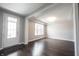 Bright living room with wood floors, white trim, and a glass paneled exterior door at 15694 Provincial Ln, Fishers, IN 46040
