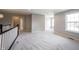 Bright loft area with neutral carpeting, and a black and white railing at 15694 Provincial Ln, Fishers, IN 46040