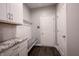 Inviting mudroom with white cabinets, granite countertops, and a convenient bench with hooks near the entrance at 15694 Provincial Ln, Fishers, IN 46040