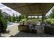 Beautiful covered patio featuring ample seating, a pool, a fire pit, and professional landscaping at 15694 Provincial Ln, Fishers, IN 46040