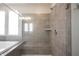 Walk-in shower with tiled walls, glass doors, a shower bench, and modern fixtures at 15694 Provincial Ln, Fishers, IN 46040