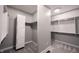 Walk-in closet featuring custom shelving, cabinets, carpet, and lighting at 15694 Provincial Ln, Fishers, IN 46040