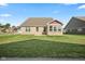 Well maintained backyard featuring a brick home and a green lawn on a sunny day at 1692 S Centennial Ave, New Palestine, IN 46163