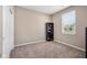 Bedroom with neutral walls, window, tan carpet, and closet at 1692 S Centennial Ave, New Palestine, IN 46163