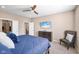 Comfortable bedroom featuring a ceiling fan, a mounted TV, and neutral-colored walls at 1692 S Centennial Ave, New Palestine, IN 46163
