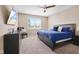 Cozy bedroom with a blue-themed decor, a ceiling fan, and natural light from the window at 1692 S Centennial Ave, New Palestine, IN 46163