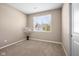Empty bedroom featuring a bright window and neutral carpeting at 1692 S Centennial Ave, New Palestine, IN 46163