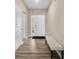 Inviting foyer with bench and durable flooring leading into the home at 1692 S Centennial Ave, New Palestine, IN 46163