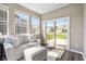 Cozy sunroom with comfortable seating and sliding door access to yard at 1692 S Centennial Ave, New Palestine, IN 46163