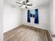 Bright, empty bedroom features a ceiling fan, blue curtains, and wood laminate flooring at 17 Crestview Dr, Greenwood, IN 46143