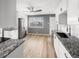 Bright kitchen with stainless steel fridge, granite countertops, and a view to the outside at 17 Crestview Dr, Greenwood, IN 46143