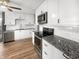 Kitchen boasts stainless steel appliances, granite countertops, and white subway tile backsplash at 17 Crestview Dr, Greenwood, IN 46143