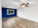 Bright living room featuring light wood floors, a ceiling fan, and ample natural light at 17 Crestview Dr, Greenwood, IN 46143