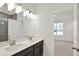 Bathroom featuring double sinks, vanity, and a doorway leading to the bedroom at 19714 Highclere Ln, Sheridan, IN 46069