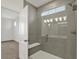 Bright bathroom featuring glass enclosed shower with neutral tile and bench at 19714 Highclere Ln, Sheridan, IN 46069