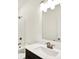 Clean bathroom with a white countertop, dark vanity, bronze fixtures, and tub-shower combo at 19714 Highclere Ln, Sheridan, IN 46069