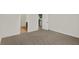 Carpeted bedroom leading to a kitchen and bathroom with neutral colored walls at 19714 Highclere Ln, Sheridan, IN 46069