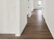 Hallway showcasing wood flooring, white walls, and connecting doors creating a spacious feel at 19714 Highclere Ln, Sheridan, IN 46069