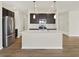 Modern kitchen with stainless steel appliances, a center island, and dark wood cabinets at 19714 Highclere Ln, Sheridan, IN 46069