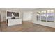 Bright, open-concept living area with hardwood floors and a view of the modern kitchen at 19714 Highclere Ln, Sheridan, IN 46069