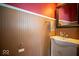Charming bathroom with beadboard wainscoting, vibrant colors, and pedestal sink at 198 E Madison St, Franklin, IN 46131