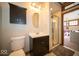 Bathroom featuring a modern vanity, oval mirror, shower, and dark cabinetry that complements the neutral color palette at 198 E Madison St, Franklin, IN 46131