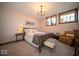 Bedroom featuring a wooden bed frame, soft lighting, and a cozy armchair that enhances the room's ambiance at 198 E Madison St, Franklin, IN 46131