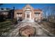 Charming brick home with a landscaped front yard, red roof, and grand entrance with beautiful steps at 198 E Madison St, Franklin, IN 46131