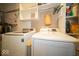 Laundry room with side-by-side washer and dryer and storage shelves at 198 E Madison St, Franklin, IN 46131