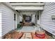 A view of the partially covered back porch, connecting the home and the garage at 2002 Fisher Ave, Indianapolis, IN 46224