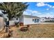 The spacious backyard has a detached garage with a sign, a firepit and some wood stumps around it at 2002 Fisher Ave, Indianapolis, IN 46224