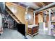 Unfinished basement area with stairs, wood paneling, a tv, and visible pipes and supports at 2002 Fisher Ave, Indianapolis, IN 46224