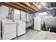 The basement laundry area features a utility sink, washer, dryer, and ample open space at 2002 Fisher Ave, Indianapolis, IN 46224