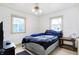 Bedroom featuring a comfortable bed with a headboard, two windows, and a ceiling fan with lighting at 2002 Fisher Ave, Indianapolis, IN 46224