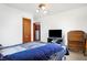Bedroom featuring a comfortable bed with a headboard, dresser, and a ceiling fan with lighting at 2002 Fisher Ave, Indianapolis, IN 46224