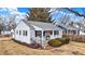 Attractive home with front porch, tidy lawn, and detached garage at 2002 Fisher Ave, Indianapolis, IN 46224